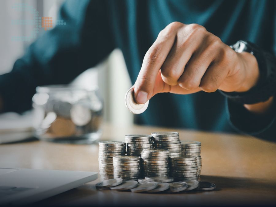 Hand stacking coins on a desk