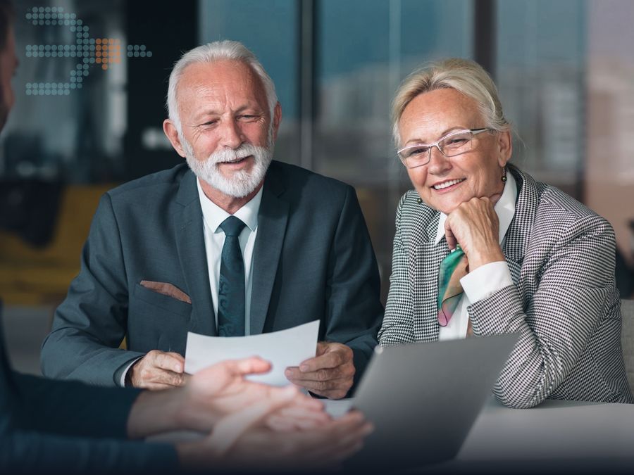Two advisers reviewing a document with a client